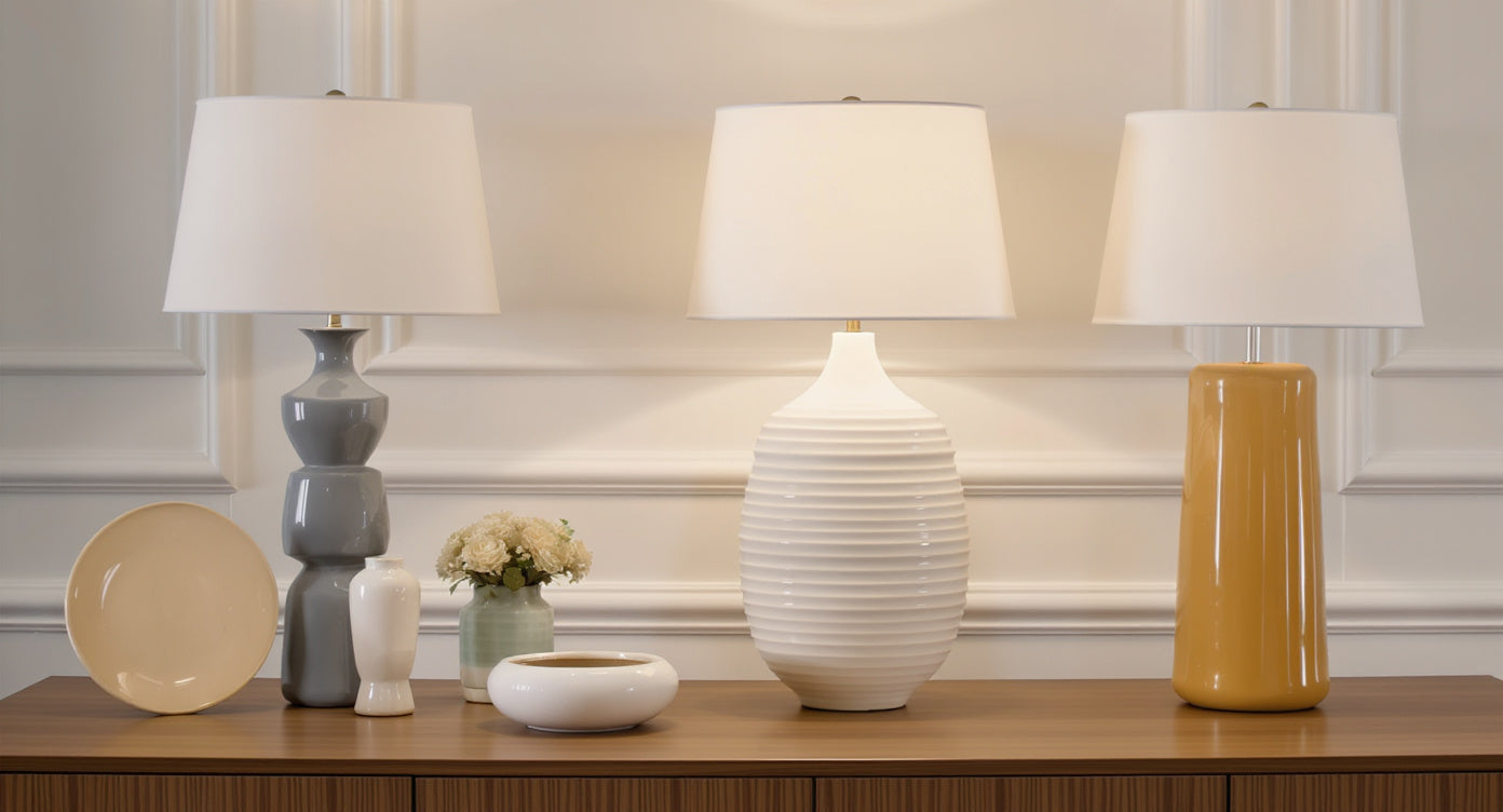 Curated collection of ceramic and brass table lamps on display shelf